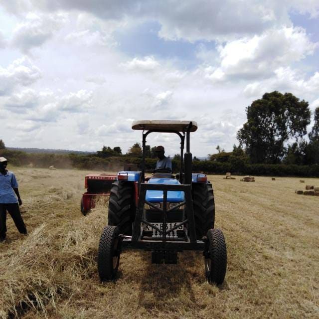 A tractor and hay baler at work in Kenya